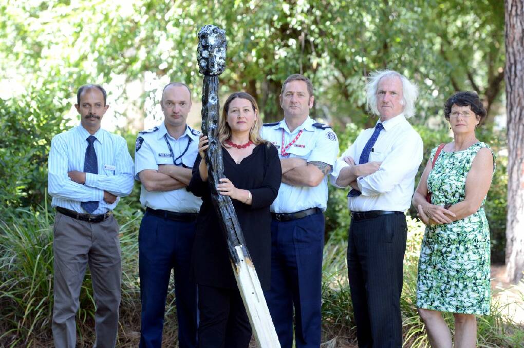 REPORT IT: Crime Stoppers chief executive Samantha Hunter holds a giant match as a symbol of the fight against arson, joined by, from left, Cr Mark Weragoda, Senior Sergeant Craig Gaffee, CFA operations manager Craig Brittain, Cr Rod Fyffe and Cr Helen Leach.  Picture: JIM ALDERSEY