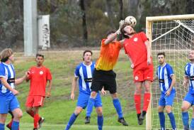 Spring Gully striker Josh Woods tries to get his head to the ball in front of Strathdale keeper Ben Kennard. Picture by Adam Bourke