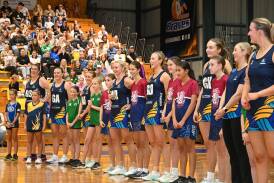 Bendigo Strikers players and junior community club players line up before the start of Sunday's VNL game. Picture by Enzo Tomasiello